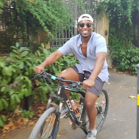 happy guy riding a bike through florence streets
