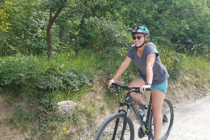 girl smiling while rides a bike