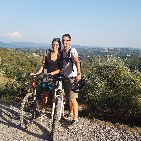 couple posing with their bikes